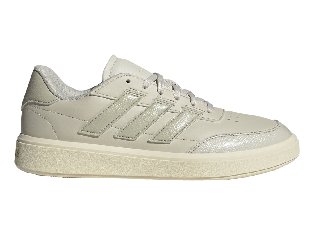 Tenis Adidas Courtblock color gris claro con franjas laterales y suela blanca.
