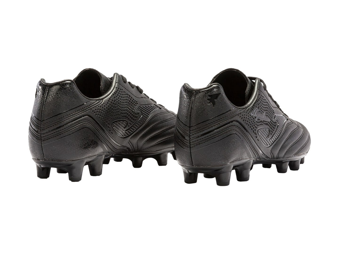 Botín de fútbol Joma Agus 2321 color negro con tacos para pasto natural.