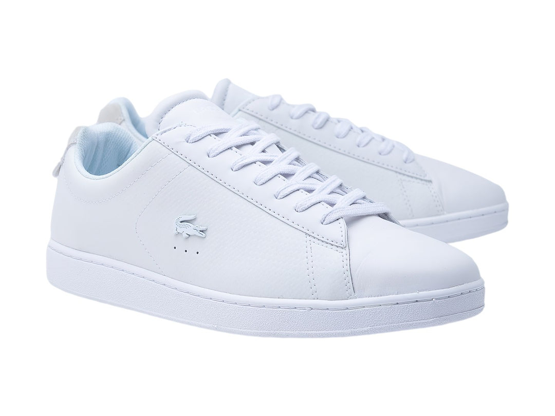 Tenis Lacoste Carnaby Evo en color blanco, de cuero liso con suela blanca y cordones.