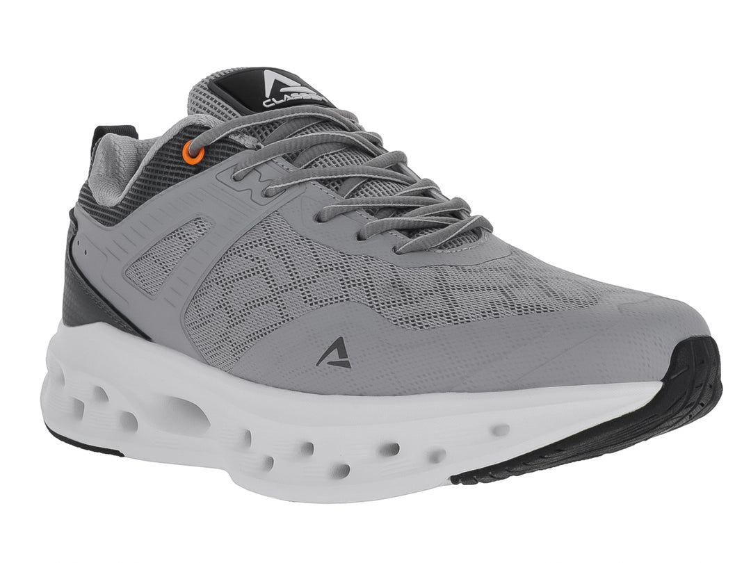 Tenis deportivos Clasben Coast en color gris oxford con suela blanca gruesa y detalles en naranja.