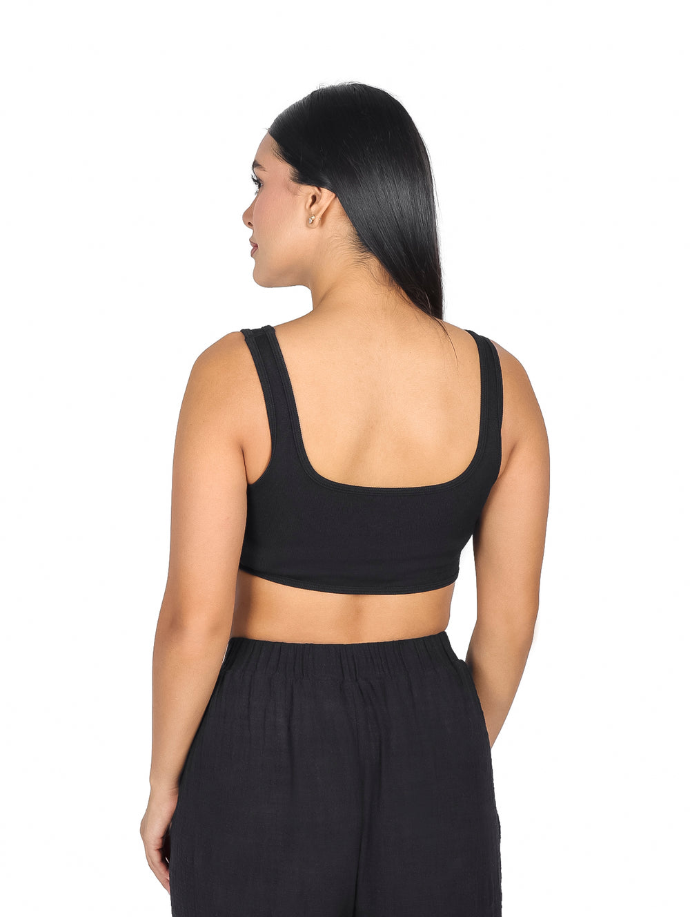 Mujer vistiendo un top tipo corset color negro de la marca ATOK.