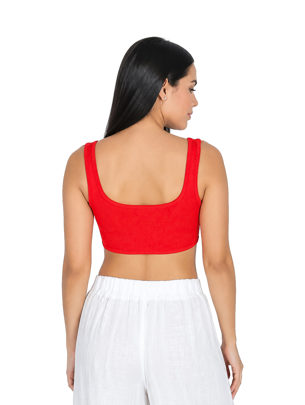 Mujer vistiendo un top tipo corset color rojo y pantalones blancos sobre fondo blanco.