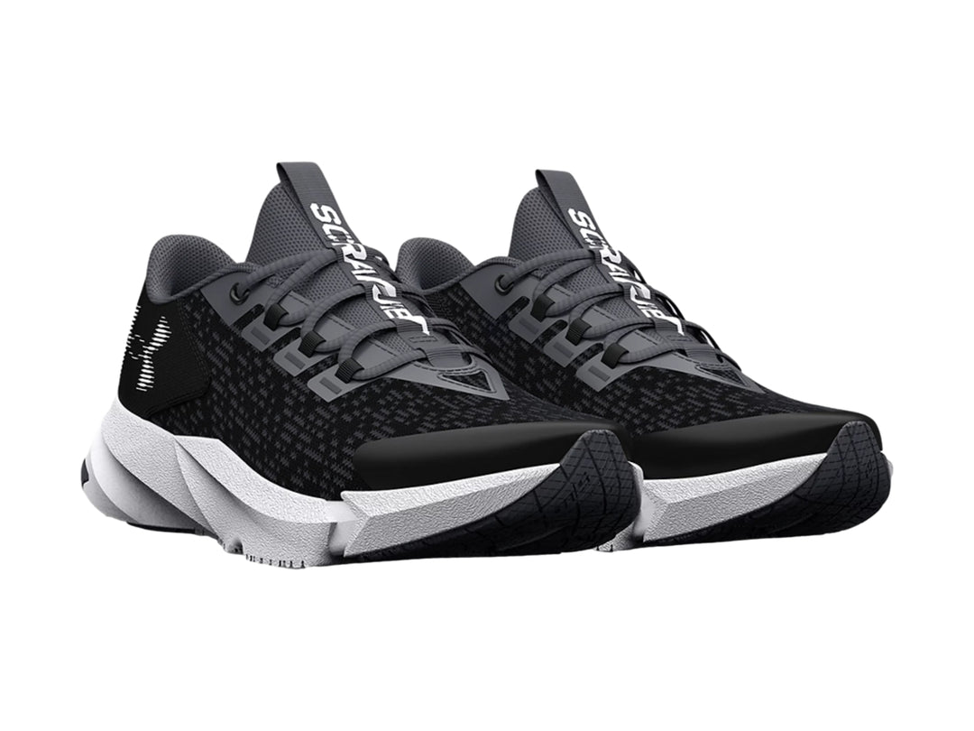 Tenis deportivos Under Armour para niño en color negro con suela blanca.