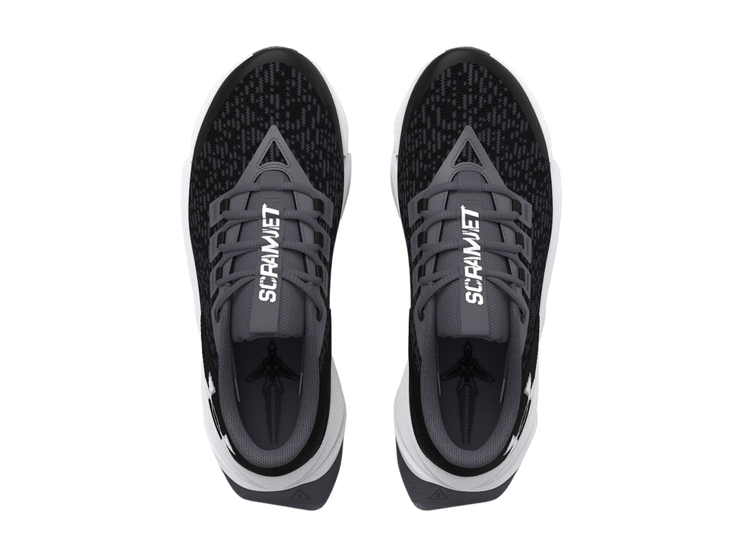 Tenis deportivos Under Armour para niño en color negro con suela blanca.