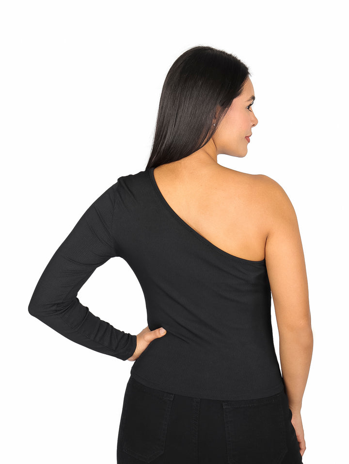 Mujer modelando blusa negra asimétrica de una sola manga y pantalones negros.