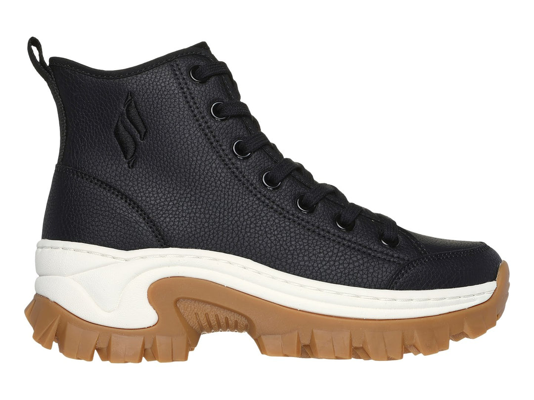 Botín Skechers negro de caña media con suela gruesa color café y detalle blanco en la entresuela.