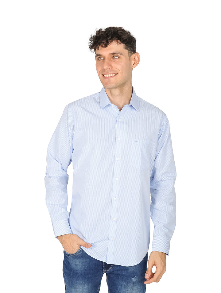 Hombre vistiendo una camisa slim fit de color azul claro con rayas blancas y pantalones vaqueros.