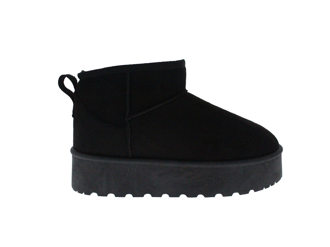 Bota corta de color negro con suela gruesa y dentada sobre fondo blanco.