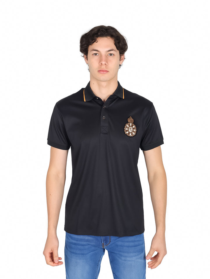 Hombre vistiendo playera polo color negro de marca Platini con detalles dorados en el cuello y escudo frontal.
