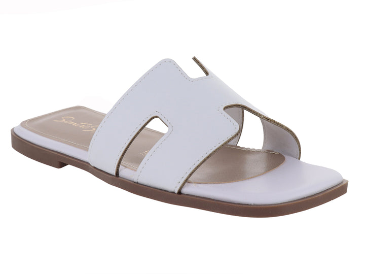 Sandalia slide blanca de cuero con suela marrón.