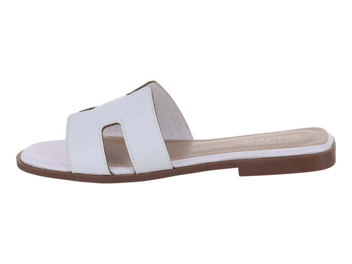 Sandalia slide blanca de cuero con suela marrón.