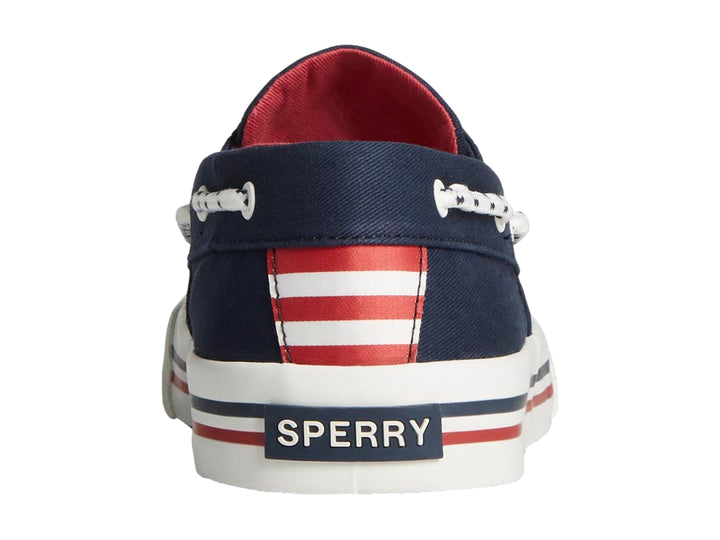 Zapato náutico Sperry azul marino con suela blanca y detalles rojos.