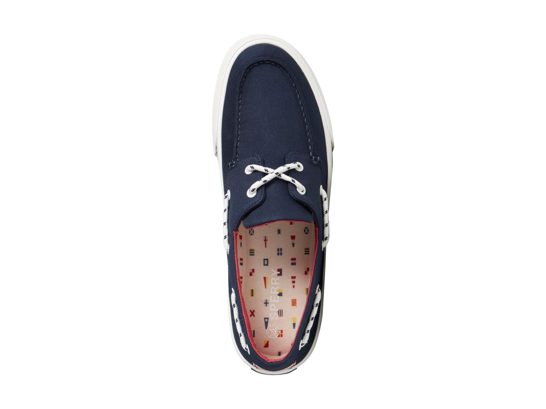 Zapato náutico Sperry azul marino con suela blanca y detalles rojos.