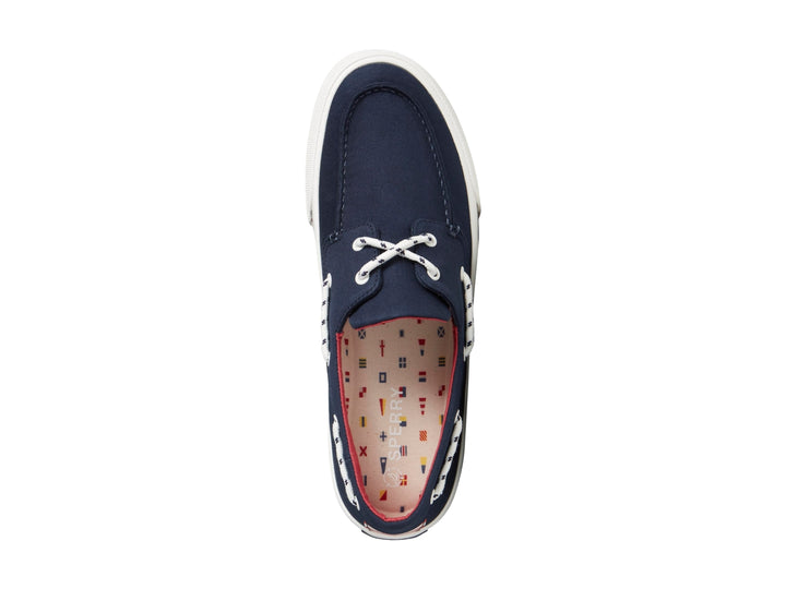Zapato náutico Sperry azul marino con suela blanca y detalles rojos.