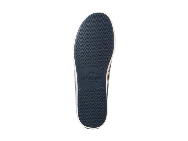 Zapato náutico Sperry azul marino con suela blanca y detalles rojos.
