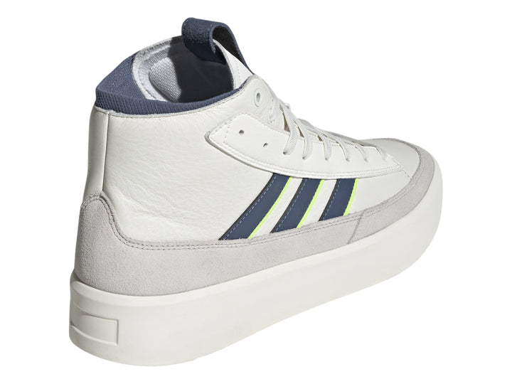 Tenis Adidas blancos de corte alto con franjas azul marino y verde lima y base gris.