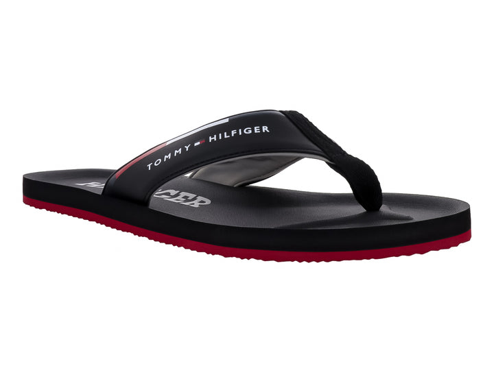 Sandalias Tommy Hilfiger color negro con suela inferior roja y logotipo blanco en la correa.