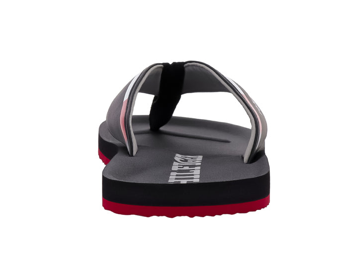 Sandalias Tommy Hilfiger color negro con suela inferior roja y logotipo blanco en la correa.