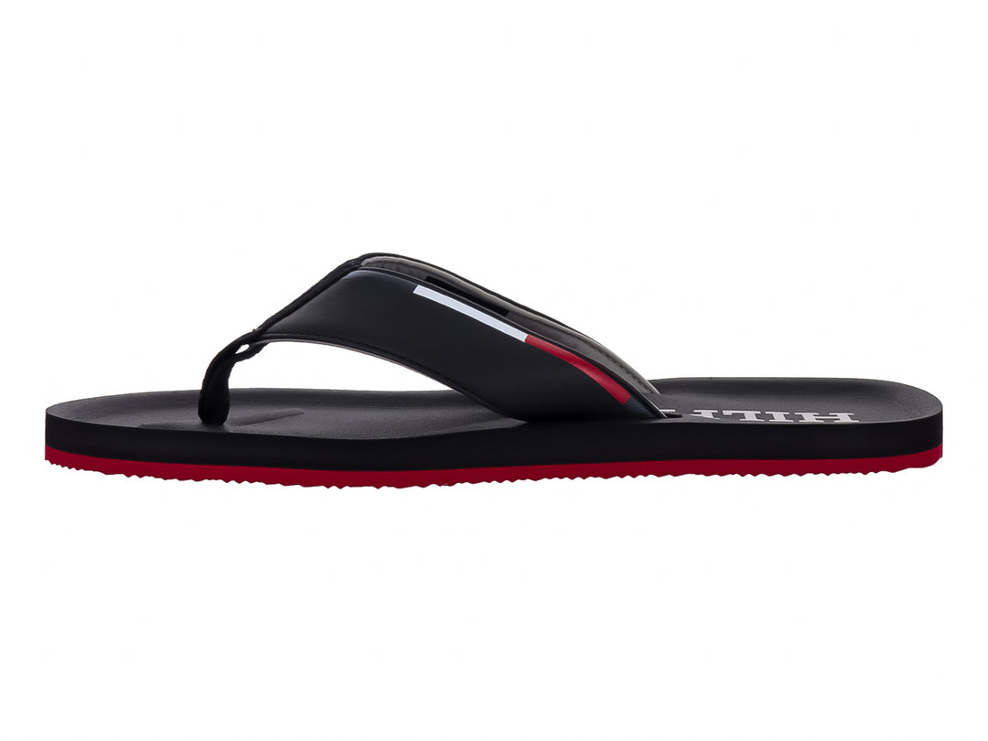 Sandalias Tommy Hilfiger color negro con suela inferior roja y logotipo blanco en la correa.