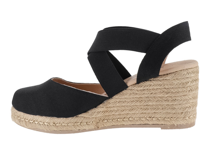 Sandalia de cuña color negro con plataforma de fibras naturales y tira ancha cruzada para mujer.