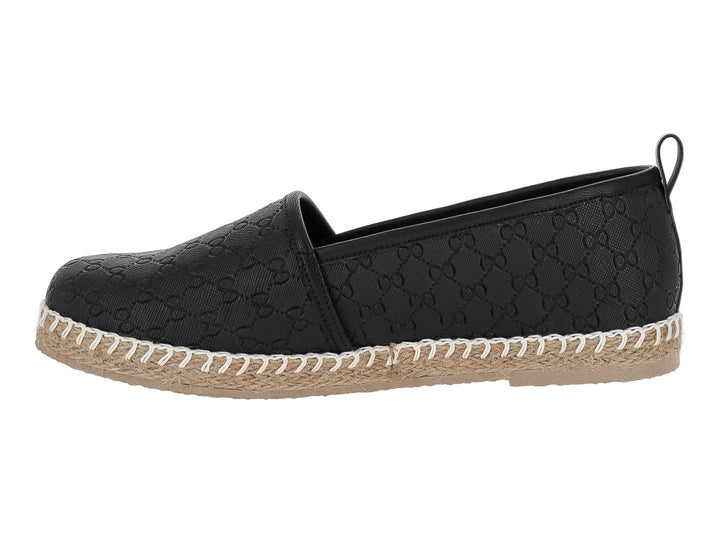 Zapato tipo alpargata color negro con suela de yute y costuras blancas decorativas.