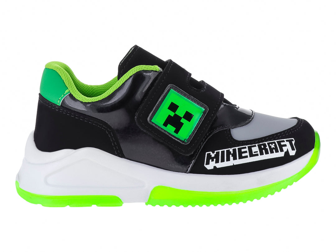 Tenis deportivos negros para niño con detalles en verde neón y blanco, con diseño inspirado en Minecraft.