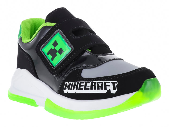 Tenis deportivos negros para niño con detalles en verde neón y blanco, con diseño inspirado en Minecraft.