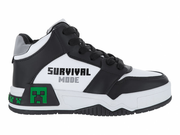 Tenis infantiles color negro y blanco con detalles verdes pixelados y texto Survival Mode.