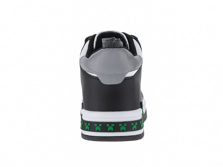 Tenis infantiles color negro y blanco con detalles verdes pixelados y texto Survival Mode.