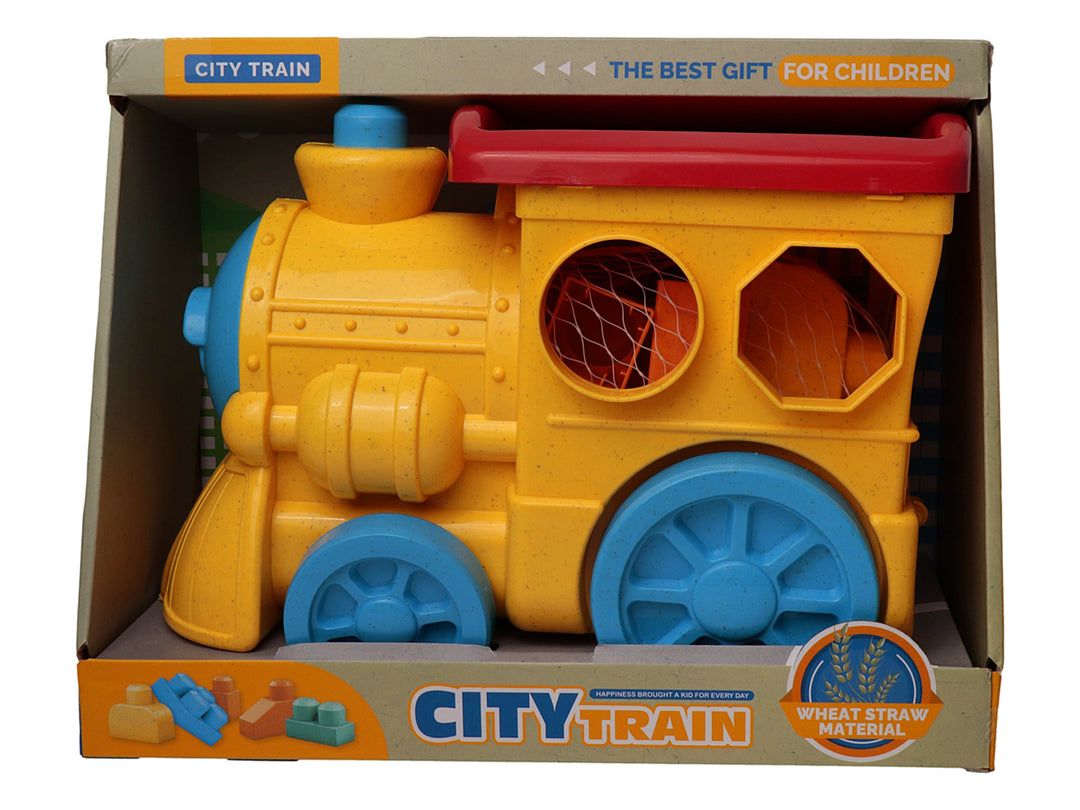 Juguete de tren amarillo con detalles en azul y rojo, fabricado en material de paja de trigo, dentro de su empaque.