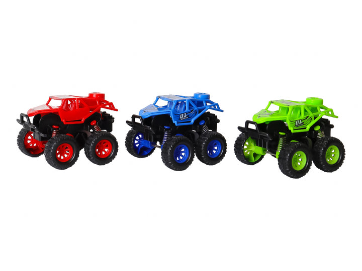 Set de tres vehículos de juguete tipo monster truck en colores verde, azul y rojo dentro de su empaque original.
