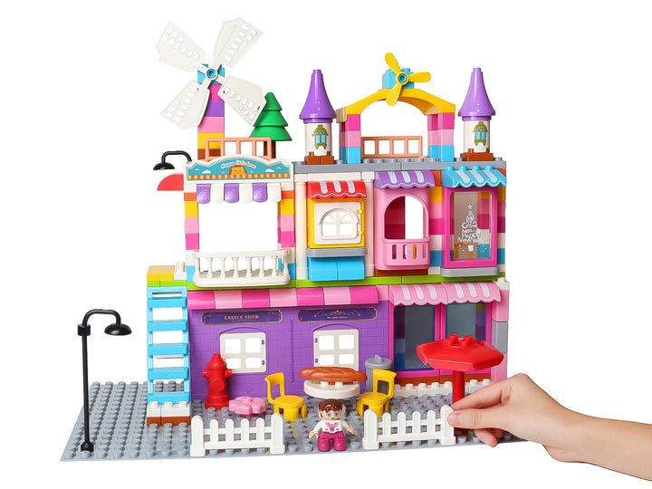 Set de bloques de construcción multicolor que forma una casa de juguete con molino y accesorios.