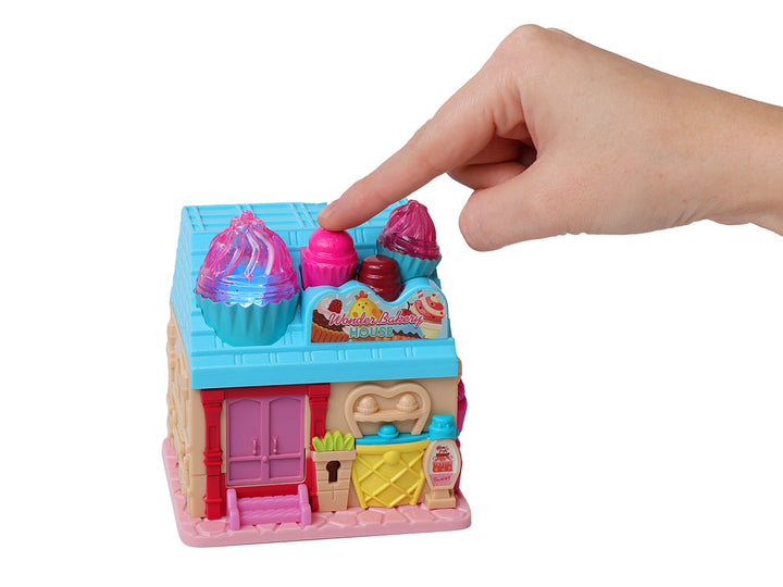 Set de juguete Wonder Bakery House en colores rosa, azul y amarillo con accesorios de panadería y figuras.