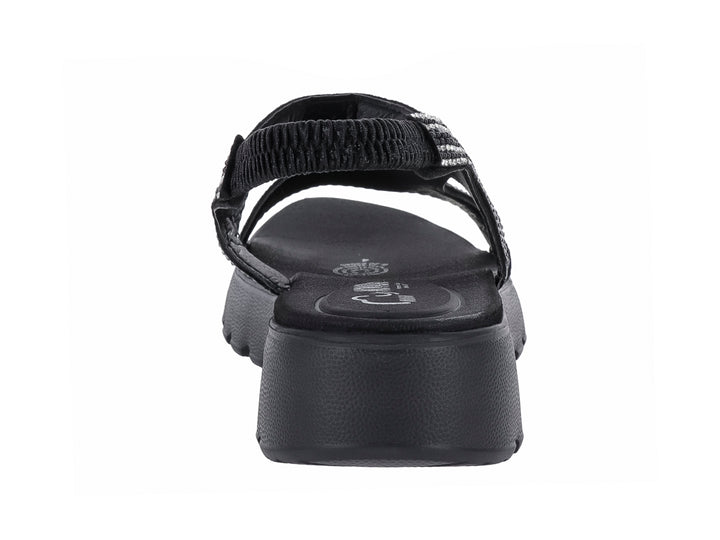 Sandalia negra de plataforma con tiras decoradas con brillantes y suela dentada.
