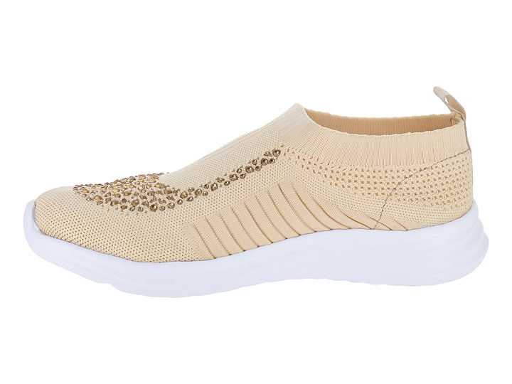 Tenis deportivos Nomadas color beige hueso con detalles brillantes en la parte frontal y suela blanca.