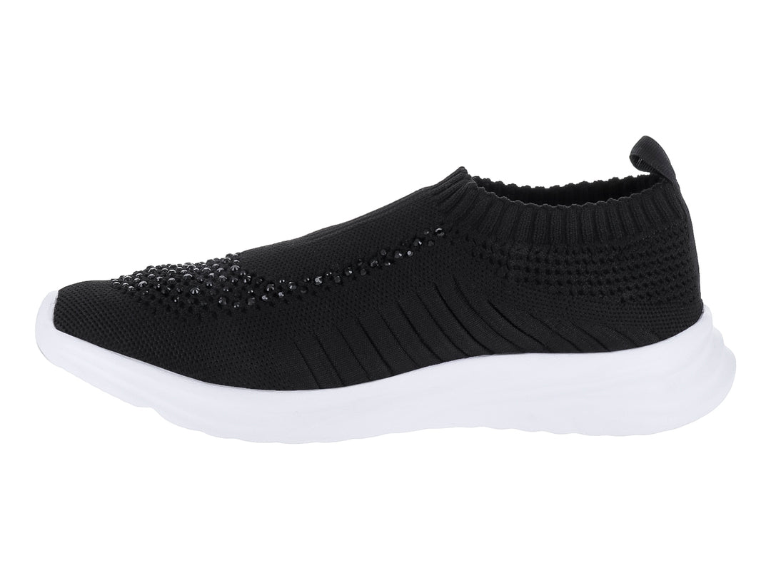Tenis negros de textil con suela blanca y detalles brillantes en la punta.