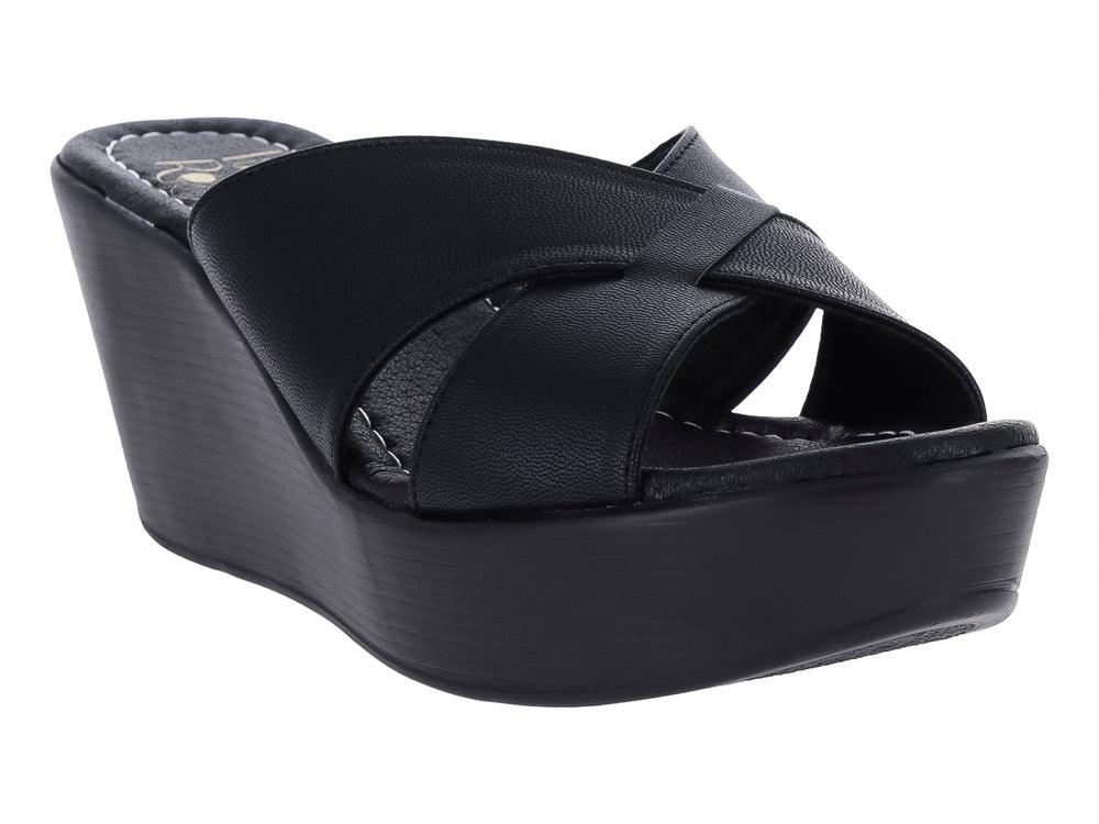 Sandalia de plataforma color negro con tiras cruzadas y suela de cuña.
