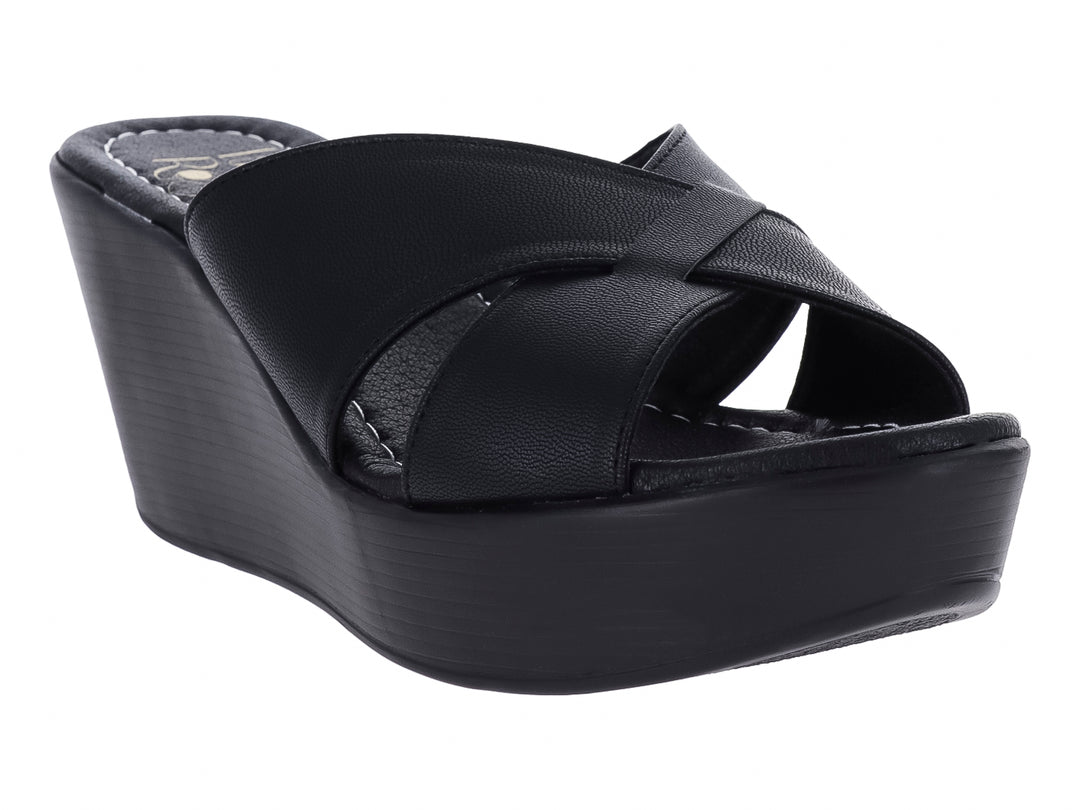 Sandalia de plataforma color negro con tiras cruzadas y suela de cuña.