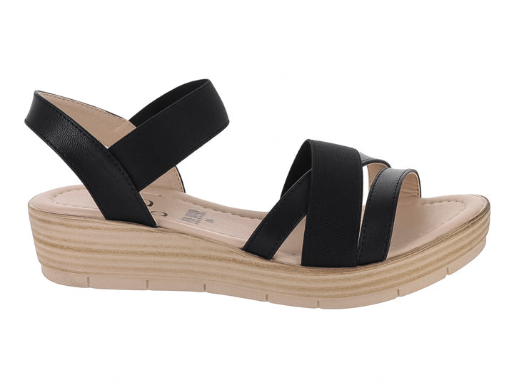 Sandalia de plataforma color negro con suela beige y tiras cruzadas.