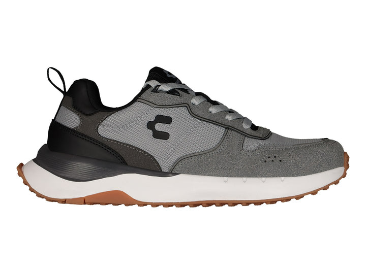 Tenis deportivos Charly color gris Oxford con detalles en negro, suela blanca y base café.