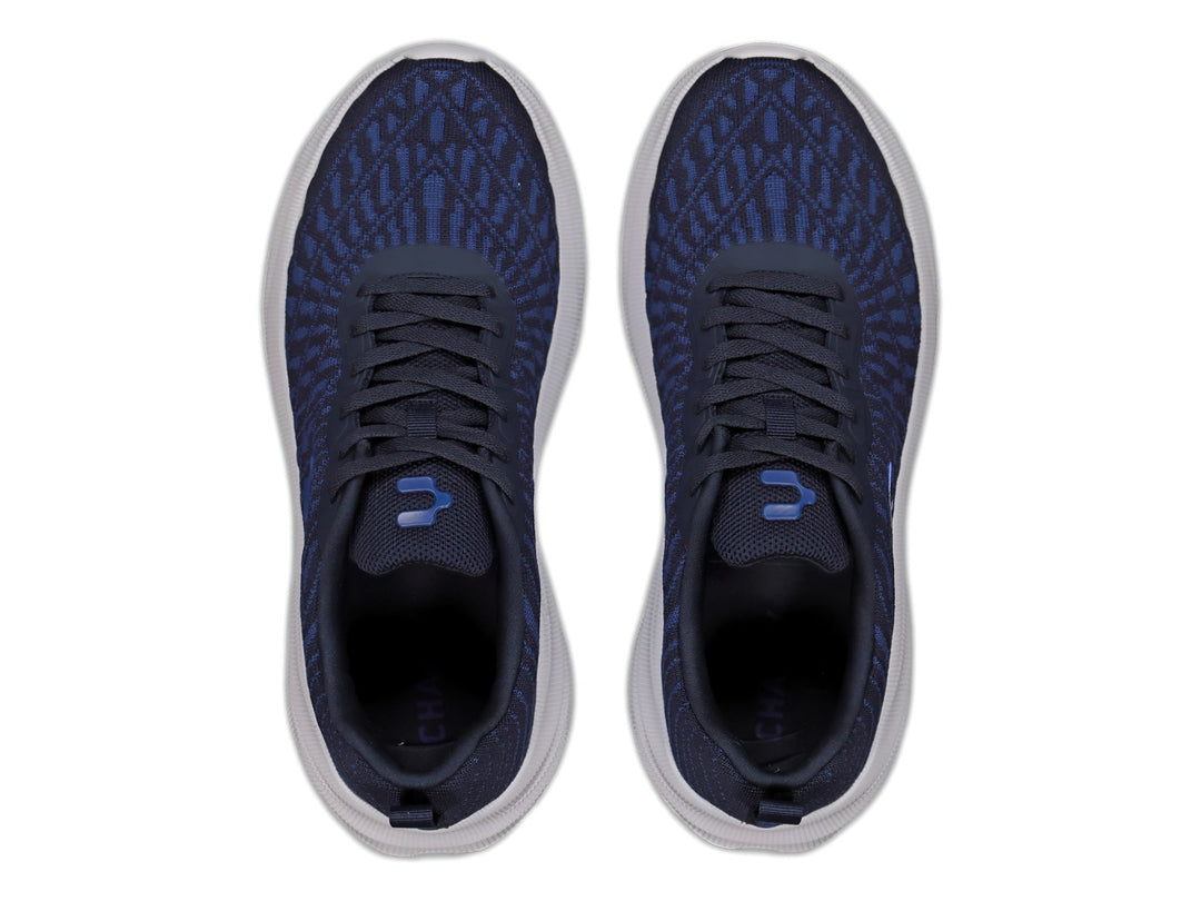 Tenis deportivos Charly color azul marino con suela blanca y tejido transpirable.