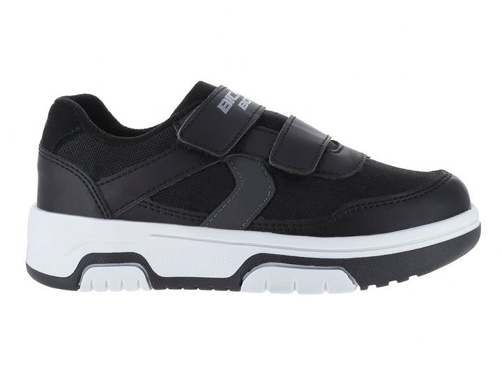 Zapato infantil color negro con suela blanca y cierre de velcro.