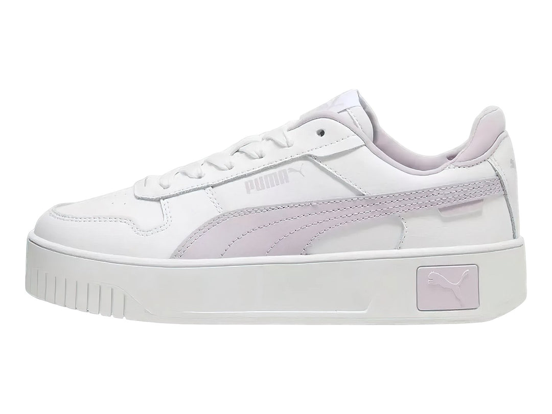 Tenis PUMA Carina Street JR color blanco con franja lila y suela de plataforma blanca.