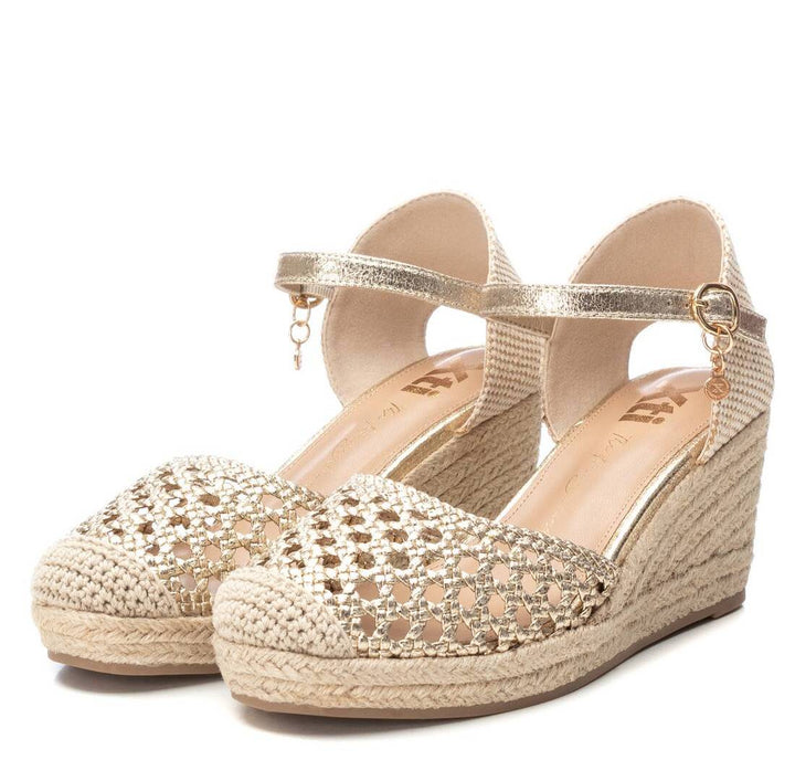Sandalias de cuña color oro con punta tejada y correa al tobillo para mujer.