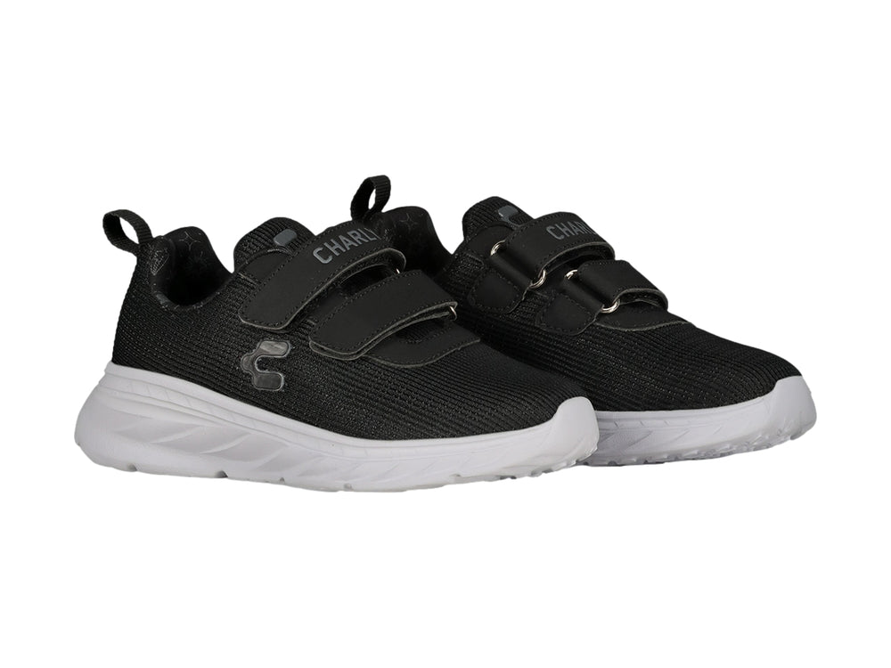 Tenis deportivos Charly color negro con suela blanca y cierres de velcro.