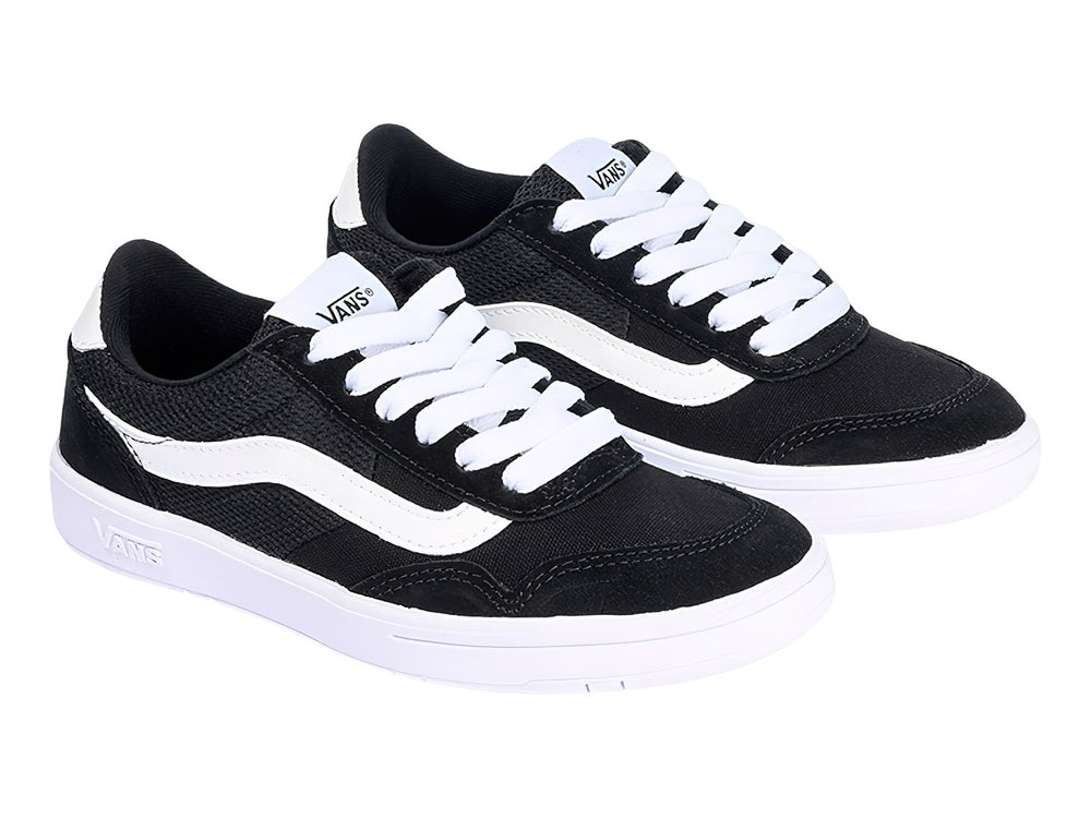 Tenis Vans color negro con franja lateral y suela en color blanco.