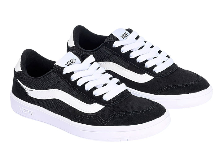 Tenis Vans color negro con franja lateral y suela en color blanco.