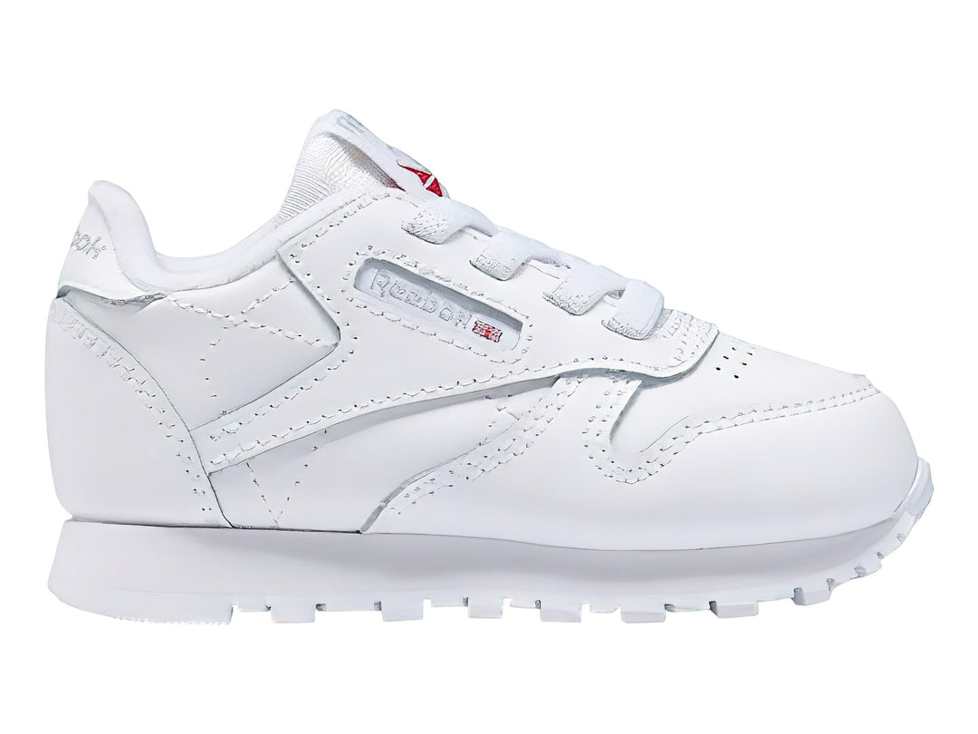 Tenis Reebok Classic Leather en color blanco con suela blanca y cordones.