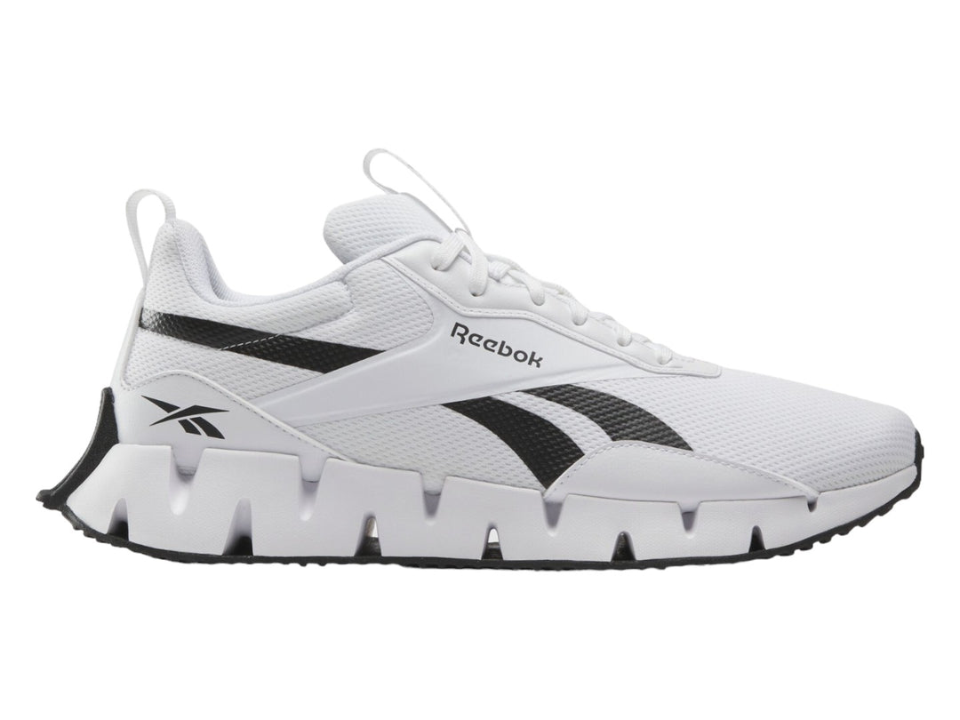 Tenis deportivos Reebok Zig Dynamica STR color blanco con detalles en negro y suela zig-zag.