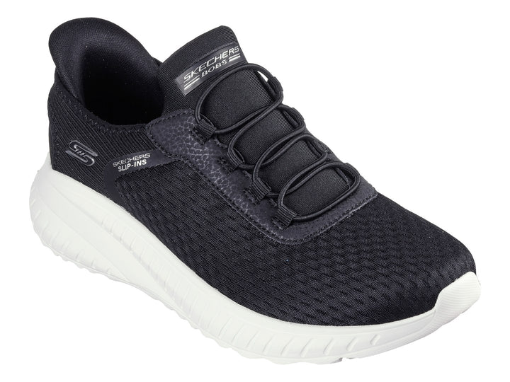 Tenis Skechers Slip-ins color negro con suela blanca gruesa y tejido transpirable.